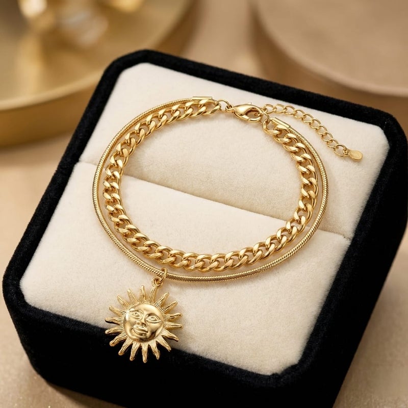 An elegant gold bracelet made of rust-resistant stainless steel, with a double design combining a wide chain and a smooth chain with an attractive sun pendant, with an adjustable clasp to suit you. - Image 4